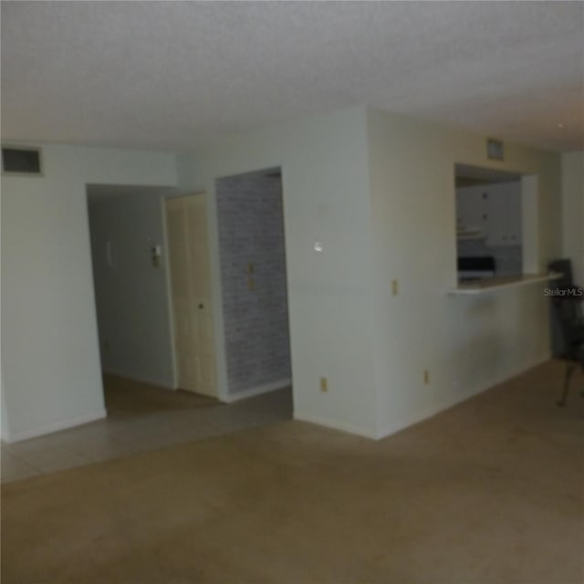 unfurnished living room with visible vents