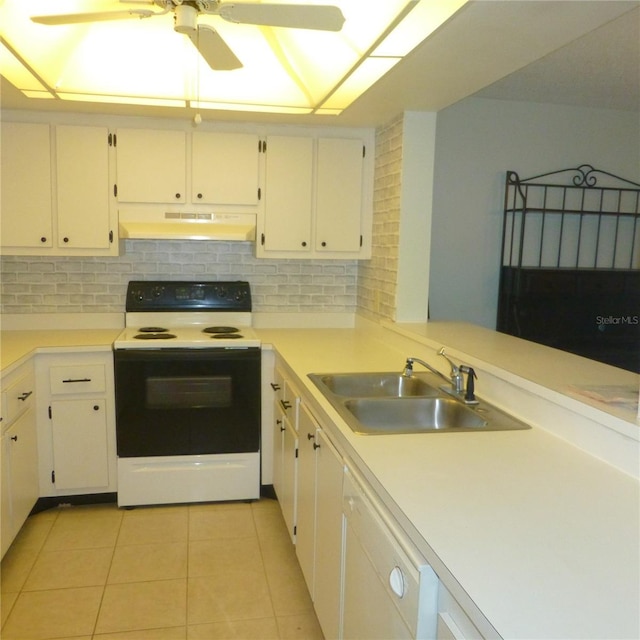 kitchen featuring under cabinet range hood, a sink, range with electric stovetop, light tile patterned floors, and decorative backsplash