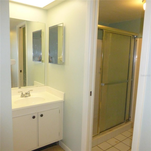 full bath with tile patterned floors, a shower stall, and vanity