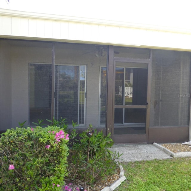 property entrance featuring board and batten siding