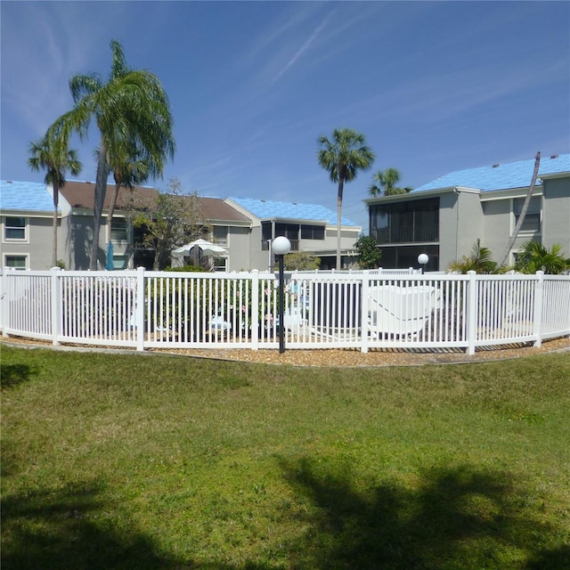 view of yard featuring a sunroom and fence