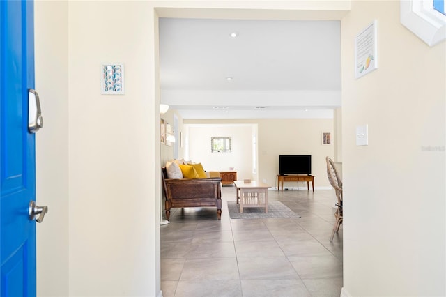 corridor featuring baseboards and tile patterned flooring