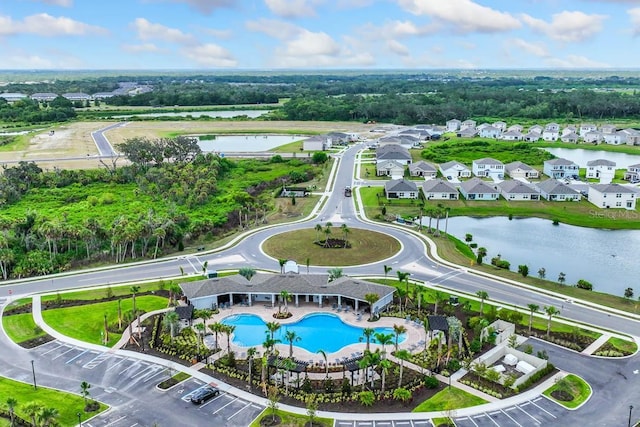 birds eye view of property with a residential view and a water view