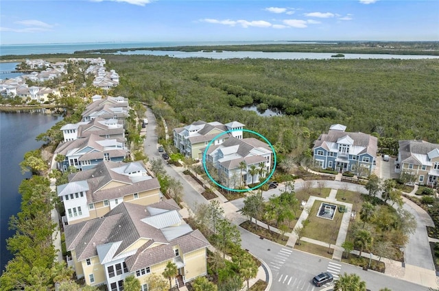 drone / aerial view with a residential view and a water view