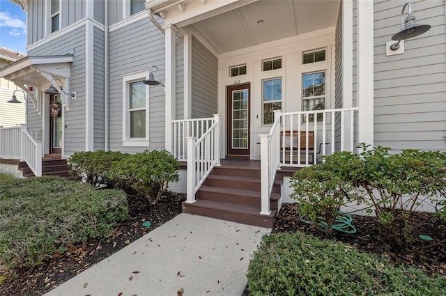 doorway to property featuring a porch and board and batten siding