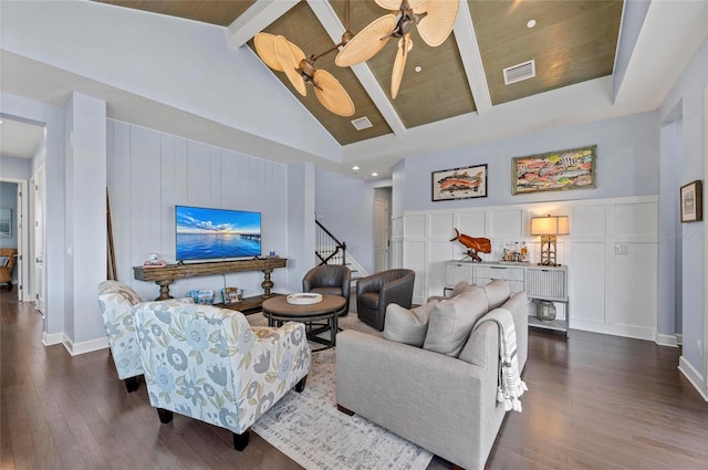 living area with visible vents, high vaulted ceiling, beam ceiling, dark wood-type flooring, and a decorative wall