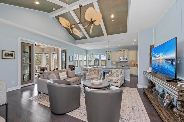 living room with beamed ceiling, high vaulted ceiling, dark wood finished floors, baseboards, and ceiling fan