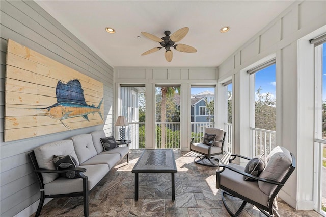 sunroom featuring ceiling fan