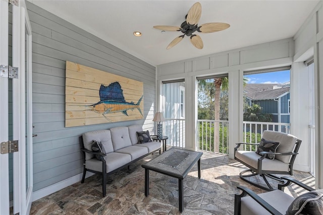 sunroom with a ceiling fan