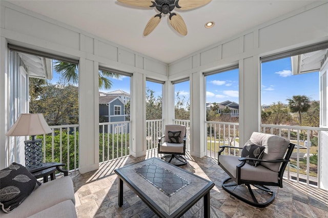 sunroom / solarium featuring ceiling fan