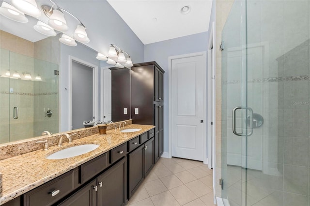 full bath with tile patterned flooring, double vanity, a stall shower, and a sink