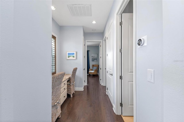 corridor with dark wood finished floors, visible vents, recessed lighting, and baseboards