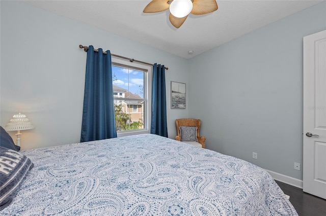 bedroom with dark wood-style floors, baseboards, and ceiling fan