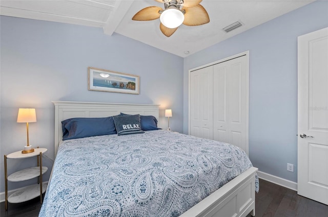 bedroom with visible vents, vaulted ceiling with beams, baseboards, dark wood-style floors, and a closet