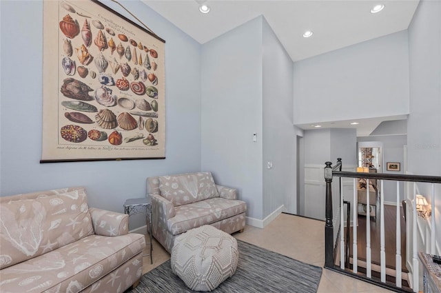 living area with tile patterned flooring, recessed lighting, an upstairs landing, and baseboards