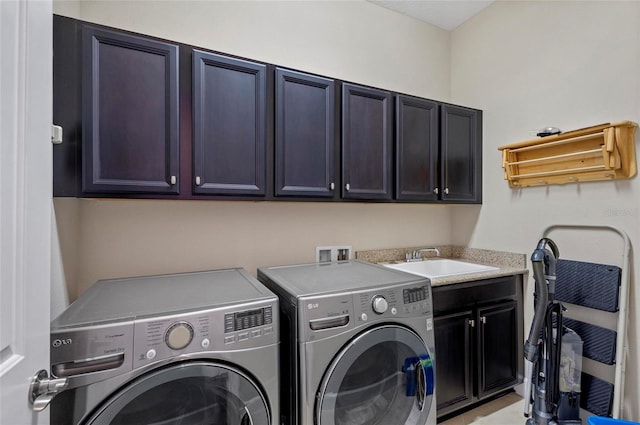 laundry area featuring a sink, cabinet space, and washing machine and dryer