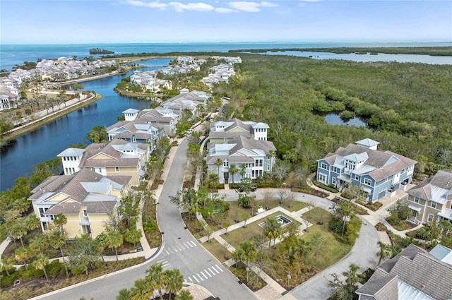 drone / aerial view with a residential view and a water view