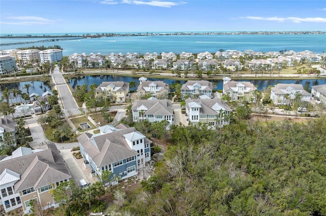 drone / aerial view with a residential view and a water view