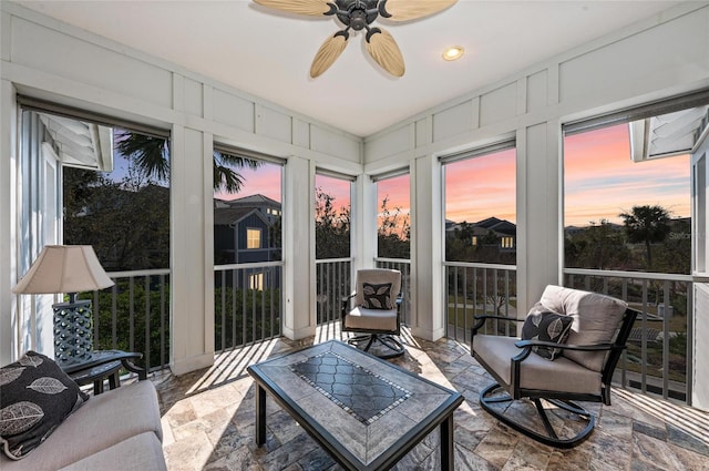 sunroom featuring a ceiling fan