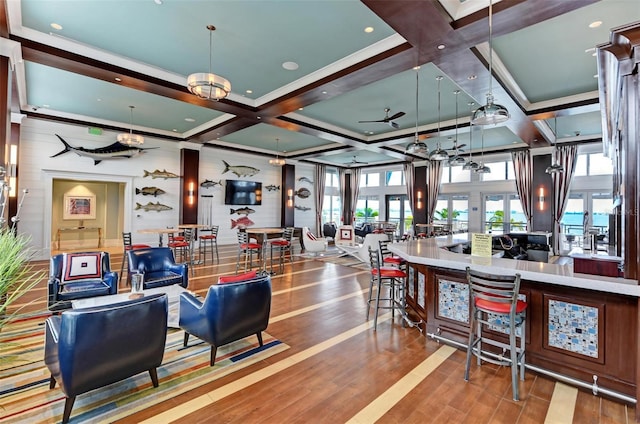 interior space featuring open floor plan, coffered ceiling, beam ceiling, and wood finished floors