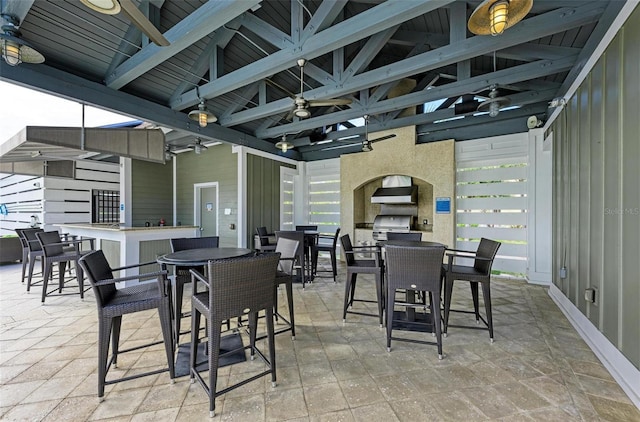 view of patio with outdoor dining space, a gazebo, outdoor wet bar, and an outdoor kitchen