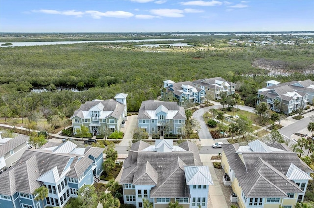 drone / aerial view featuring a residential view and a water view