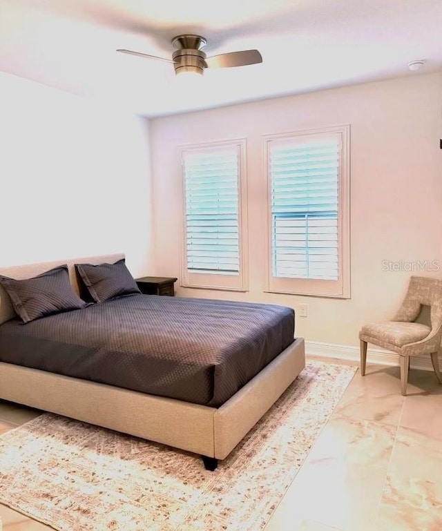 bedroom with baseboards and ceiling fan