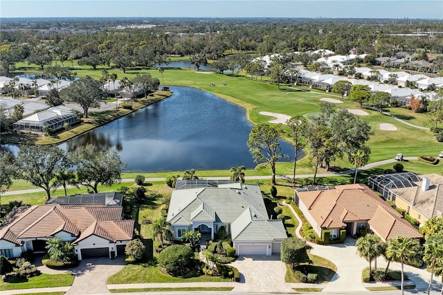 drone / aerial view featuring a residential view, a water view, and golf course view