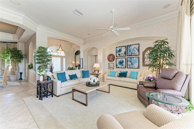 living room featuring visible vents, crown molding, ceiling fan, light tile patterned flooring, and arched walkways