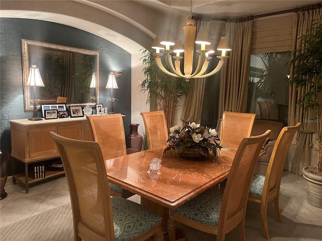 dining room with light tile patterned flooring and an inviting chandelier