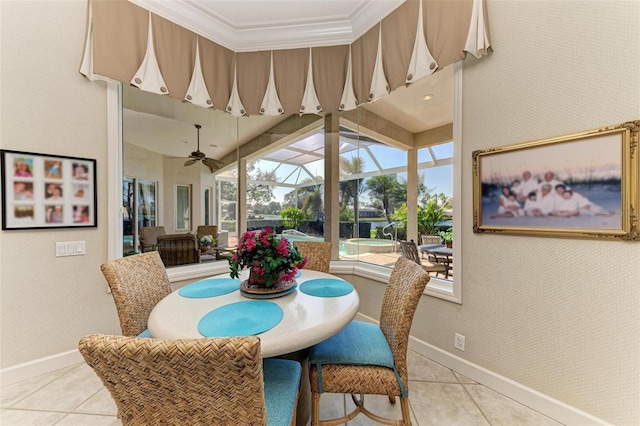 dining space with light tile patterned flooring, wallpapered walls, baseboards, and a sunroom