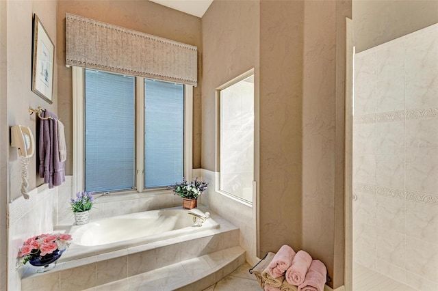 bathroom with tiled shower and a garden tub