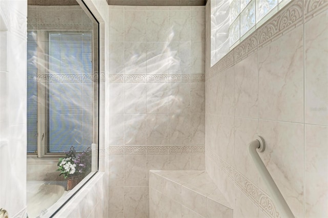 bathroom featuring a bathtub and tiled shower