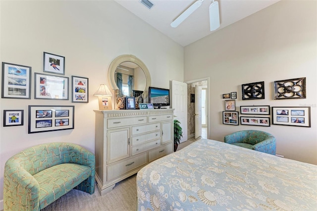 bedroom featuring visible vents, high vaulted ceiling, ceiling fan, and light colored carpet