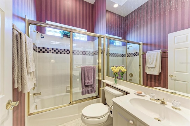 bathroom with tile patterned floors, toilet, wallpapered walls, bath / shower combo with glass door, and vanity