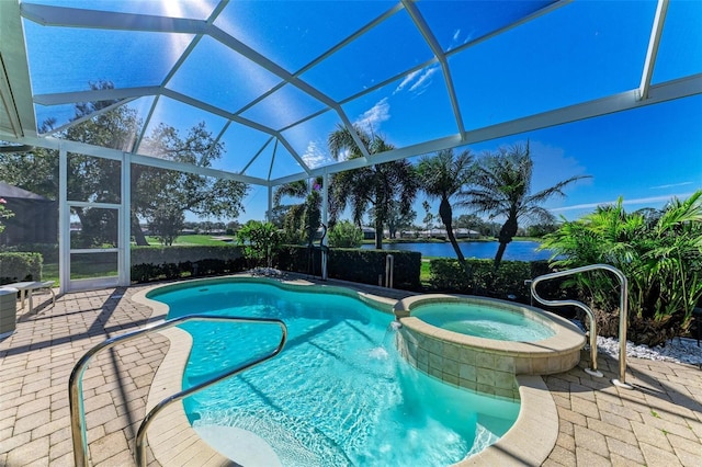 view of swimming pool featuring a patio, a lanai, a water view, and a pool with connected hot tub