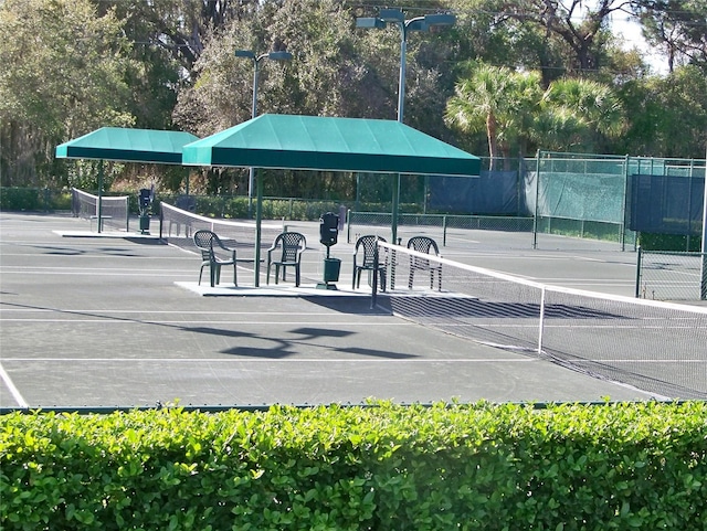 view of sport court featuring fence