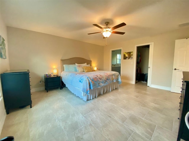 bedroom featuring baseboards, a spacious closet, and a ceiling fan