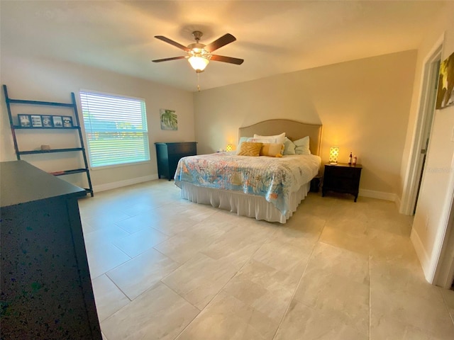 bedroom featuring light tile patterned flooring, a ceiling fan, and baseboards