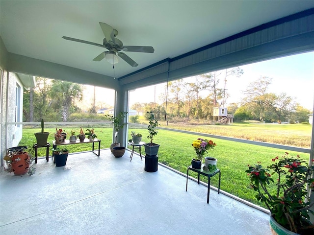 unfurnished sunroom with ceiling fan