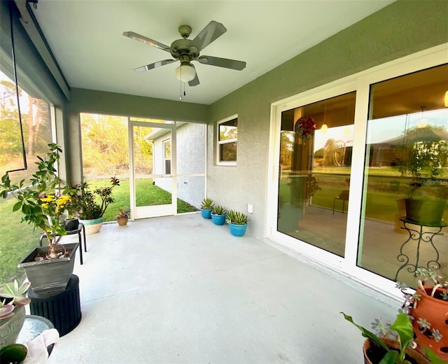 sunroom with a healthy amount of sunlight and a ceiling fan