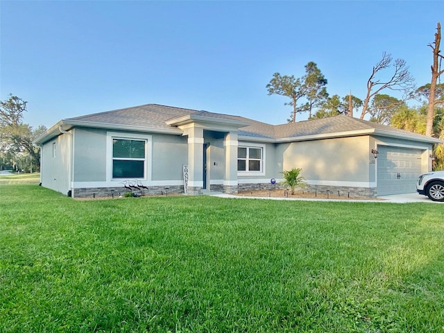 prairie-style house with a shingled roof, a front yard, an attached garage, and stucco siding