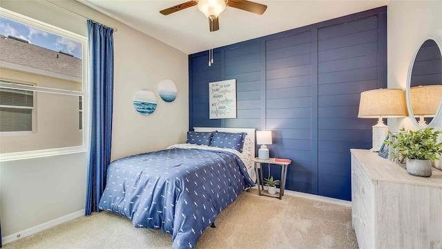 bedroom with carpet, baseboards, and a ceiling fan