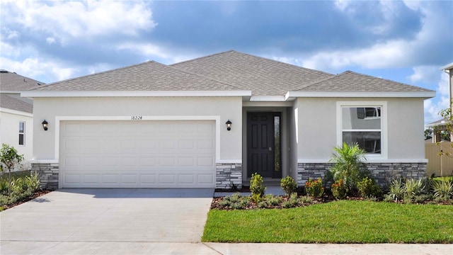18224 Metado Dr, Lakewood Ranch, FL 34211 - view of front facade with stone siding, an attached garage, driveway, stucco siding, and roof with shingles