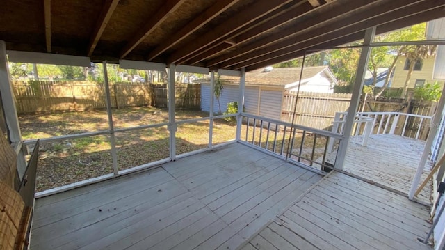 wooden deck featuring an outbuilding and a fenced backyard