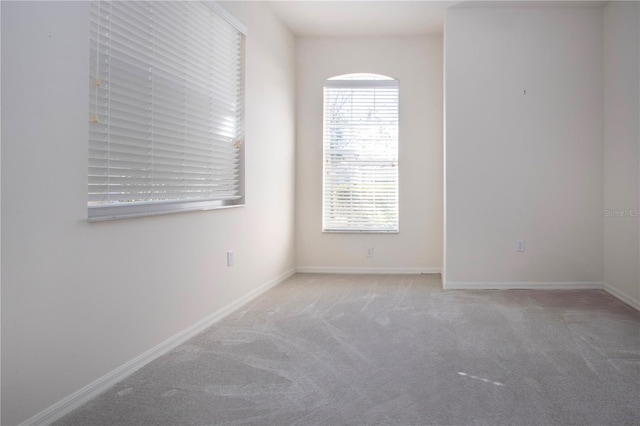 spare room with carpet flooring and baseboards