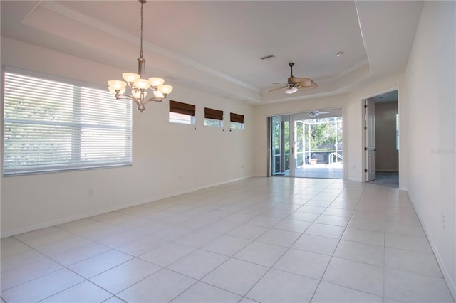 empty room featuring a raised ceiling, light tile patterned floors, crown molding, and baseboards