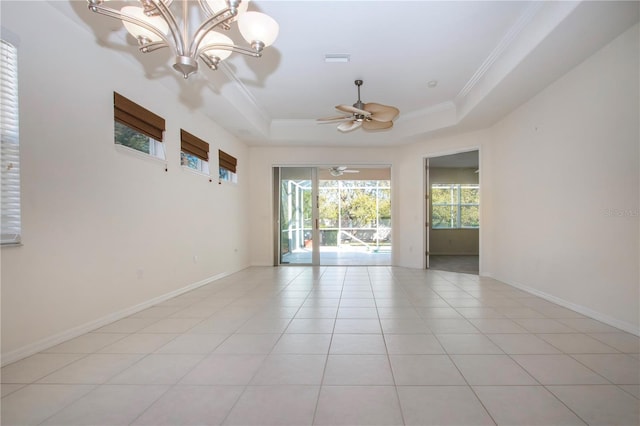 unfurnished room featuring a tray ceiling, baseboards, ornamental molding, and light tile patterned flooring