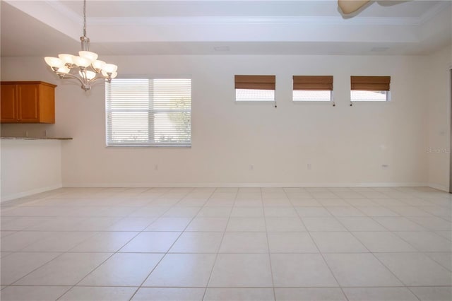 unfurnished room with light tile patterned floors, baseboards, and crown molding