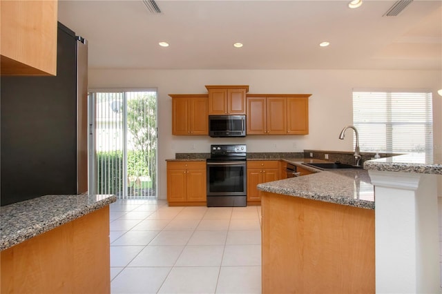 kitchen with visible vents, dark stone counters, recessed lighting, appliances with stainless steel finishes, and a sink